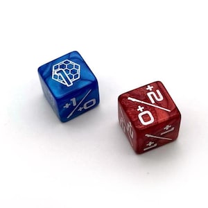 May include: Two dice, one blue and one red, with white markings. The blue die has a honeycomb symbol and the red die has a sword symbol.