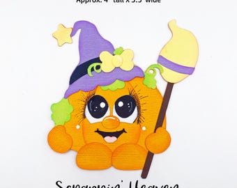 May include: A whimsical orange pumpkin character wearing a purple witch hat with a yellow star and bow, holding a broom. The image is approximately 4 inches tall and 3.5 inches wide. The text "Scrappin' Heaven" is at the bottom.