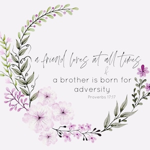 May include: Watercolor floral design with the text "a friend loves at all times & a brother is born for adversity Proverbs 17:17". The design features a wreath of green leaves, purple and pink flowers, and berries on a white background.