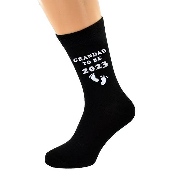 Grandad to Be 2023 with Footprint Design printed in White Vinyl on Mens Black Cotton Blend Socks. Great Present