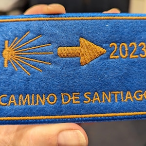 May include: A set of three ceramic mugs with a speckled, matte finish. The mugs are in shades of cream, light gray, and dark gray. Each mug has a simple, minimalist design and a rounded handle.