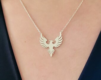 May include: A silver necklace with a phoenix pendant. The phoenix is a mythical bird that symbolizes rebirth and renewal.