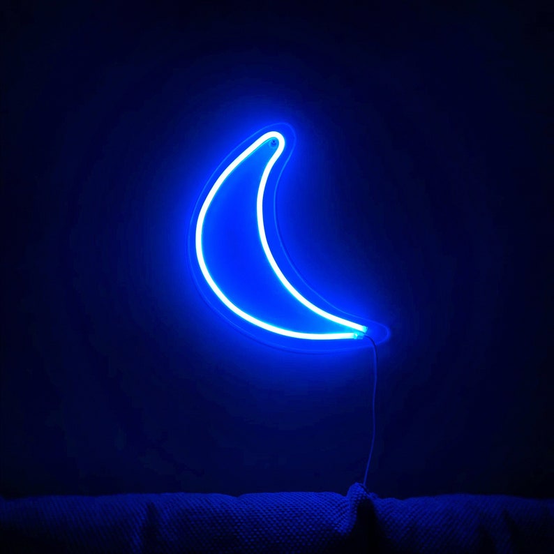 May include: A blue neon crescent moon light fixture on a dark background.