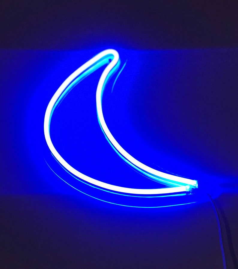 May include: A white neon crescent moon sign with a blue glow.
