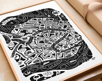 May include: Black and white line art map of Venice, Italy. The map shows the canals and islands of the city, including the Grand Canal, the Rialto Bridge, and the islands of Murano, Burano, and Torcello. The map is framed in a light wood frame.