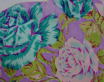 May include: A purple fabric with a floral pattern featuring pink, green, and blue roses.