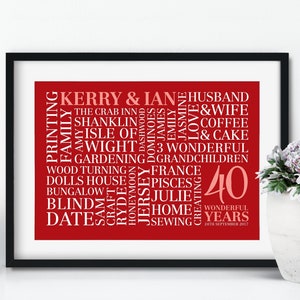May include: A red and white word cloud print celebrating a 40th anniversary. The print features the names Kerry and Ian, along with words like "husband", "wife", "family", "love", "coffee", "cake", "gardening", "France", "home", and "sewing". The date "24th September 2017" is also included.