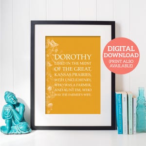 May include: A yellow printable wall art print with black text that reads "Dorothy lived in the midst of the great, Kansas prairies, with Uncle Henry, who was a farmer, and Aunt Em, who was the farmer's wife."