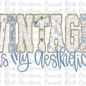 May include: A graphic design with the words "VINTAGE is My Aesthetic". The word "VINTAGE" is in large, block letters with floral and script patterns, outlined in gold and light blue. The phrase "is My Aesthetic" is in a cursive, light blue font.