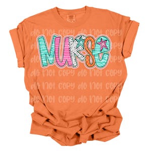 May include: Orange t-shirt with a colorful "NURSE" graphic design. The letters are decorated with different patterns and a star.