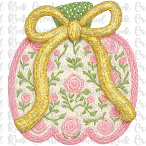 May include: A decorative pumpkin design with a gold glitter bow and stem. The pumpkin is cream-colored with pink roses and green leaves. The border is pink. The design is reminiscent of embroidery.
