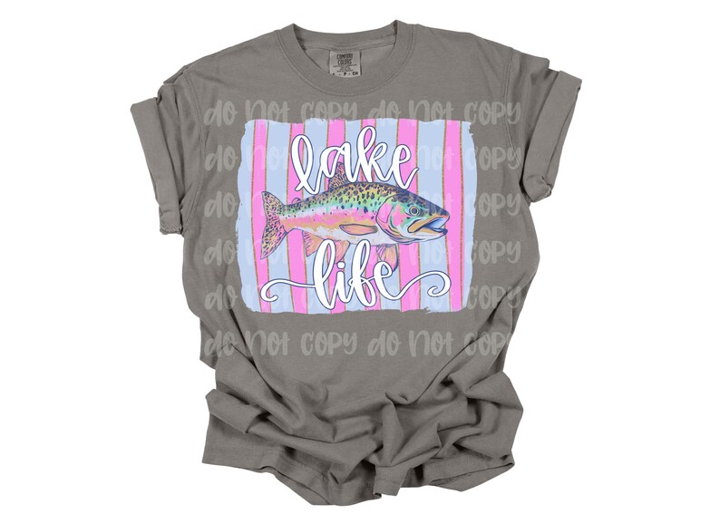 May include: A gray t-shirt with a pink and blue striped design featuring a rainbow trout and the text "lake life".