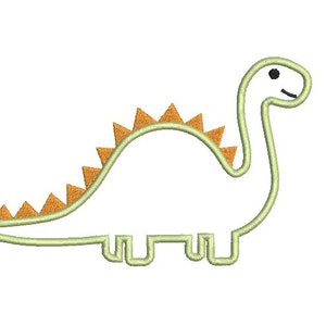 May include: A green dinosaur outline with orange spikes on its back. The dinosaur has a simple, cartoon-like design.