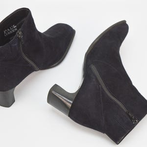 Könnte beinhalten: Ein Paar schwarze Wildlederstiefeletten mit seitlichem Reißverschluss und Blockabsatz. Die Stiefeletten sind von Paul Green.