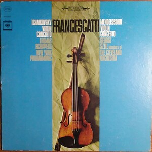 May include: A vintage vinyl record album cover featuring a violin with a light brown body and a dark brown neck. The album cover is split into three sections: the left section is blue, the middle section is a crumpled brown paper background, and the right section is blue. The text on the cover reads "FRANCESCATTI" in large white letters, "TCHAIKOVSKY VIOLIN CONCERTO" in smaller white letters, "MENDELSSOHN VIOLIN CONCERTO" in smaller white letters, "THOMAS SCHIPPERS NEW YORK PHILHARMONIC" in smaller white letters, and "GEORGE SZELL Members of THE CLEVELAND ORCHESTRA" in smaller white letters.
