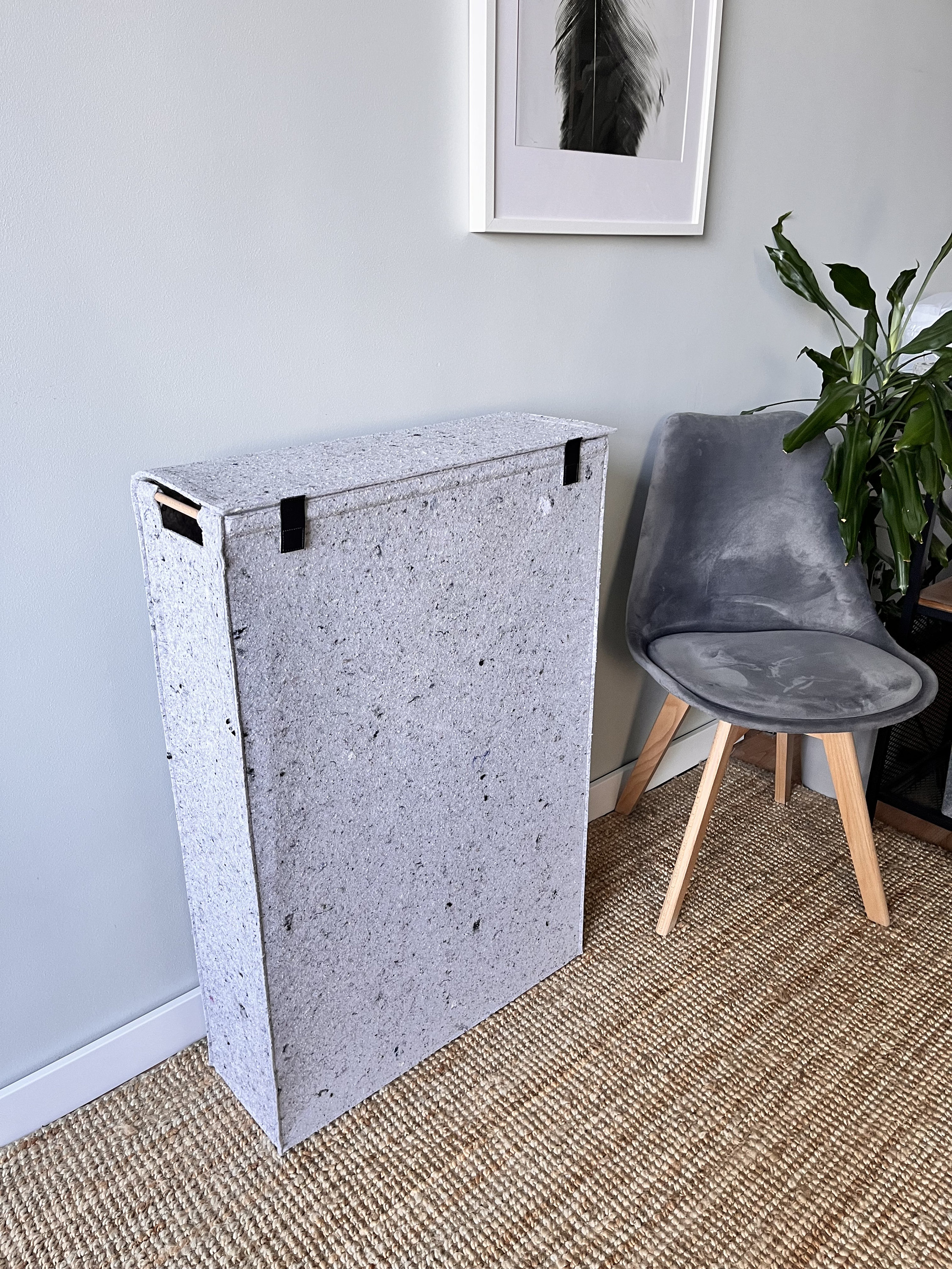 Narrow felt laundry hamper with flip lid.