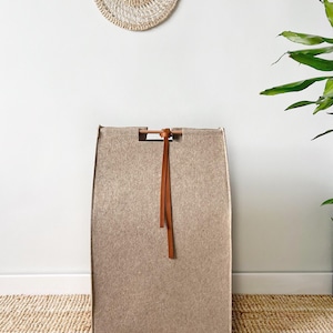 Tall and narrow laundry hamper with wooden handles