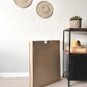 Extra narrow laundry hamper with wooden handles. Small bathroom storage basket