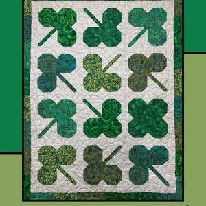 May include: A quilt pattern featuring a green clover patch design. The quilt is made up of nine individual clover patches, each with a different green fabric. The quilt is surrounded by a white border and a green outer border. The text "Clover Patch" is at the top of the image. The text "Molly Cook for Villa Rosa Designs" is at the bottom of the image.