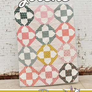 May include: A colorful quilt with a geometric pattern. The quilt features a repeating design of diamonds in various colors, including pink, green, yellow, and white. The word "Jolene" is written in cursive at the top.