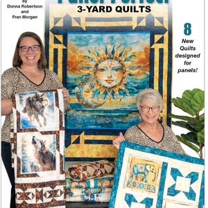 May include: Two women holding quilts. The quilts feature images of wolves, elephants, and a sun and moon design. The book cover reads "Panel Perfect 3-Yard Quilts" and "8 New Quilts designed for panels!" by Donna Robertson and Fran Morgan.