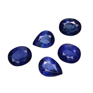 May include: Five loose, deep blue sapphires of varying shapes. Two are oval, and three are pear-shaped. The gemstones are displayed against a white background, showcasing their facets and rich color. Ideal for jewelry making.
