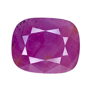 May include: A cushion-cut gemstone with a vibrant magenta-pink hue. The stone features a faceted surface that reflects light, creating a geometric pattern of triangles and a central rectangle across its polished, translucent face.