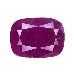 May include: A cushion-cut gemstone with a deep magenta-pink hue and a faceted surface. The stone features a symmetrical arrangement of triangular and trapezoidal facets that reflect light, creating a clear geometric pattern across the top.