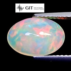 May include: An oval opal gemstone, held by tweezers, against a black backdrop. The opal shows a play of colour with iridescent hues of pink, blue, and green. The GIT logo is visible in the top left corner.