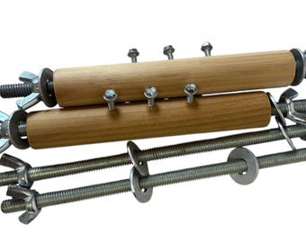 May include: A wooden dowel rod clamping tool with two metal rods and wing nuts. The tool is used to clamp two pieces of wood together.