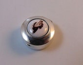 Silver pill snuff box depicting a sexy lady in enamel.
