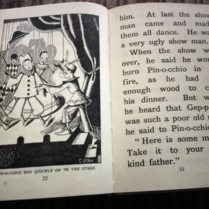 May include: An open book with a black and white illustration of a scene from Pinocchio. The illustration shows characters on a stage, with text that reads "Pin-occhio ran quickly on to the stage".