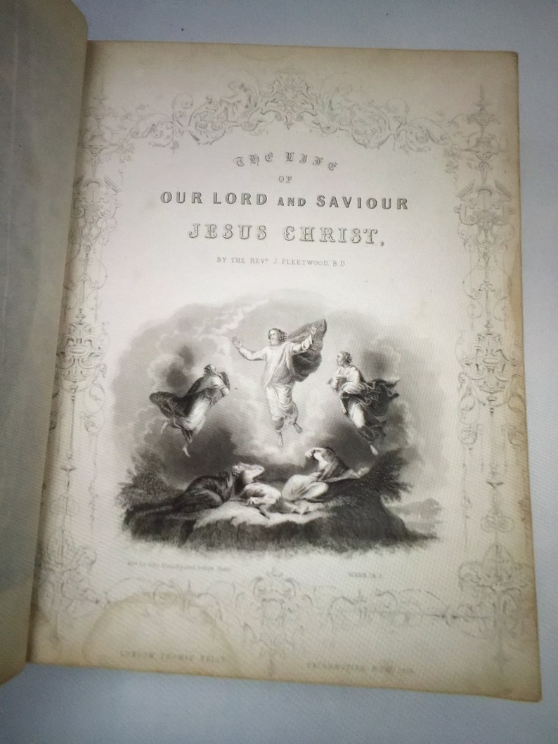 May include: A black and white illustration of a religious scene depicting Jesus Christ ascending to heaven with two angels. The text "The Life of Our Lord and Saviour Jesus Christ, By the Rev. J. Fleetwood, B.D." is printed on the page.
