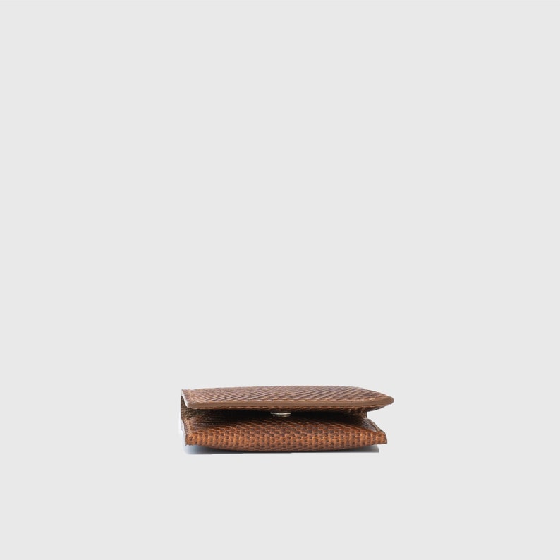 premium leather air tag wallet made of brown snake print leather by Geometric Goods