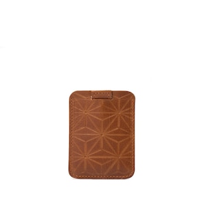 designers iphone magsafe wallet for much more cards than apples official iphone wallet in cognac brown color made from premium italian leather by geometric goods with hand carved geometric flowers pattern