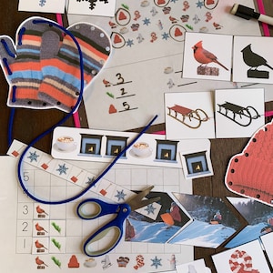 May include: A set of winter-themed educational activities for kids, including a counting activity with cardinals, a matching game with mittens, a snowflake puzzle, and a snowman activity. The set also includes a picture of a sled, a fireplace, and a cup of hot chocolate.