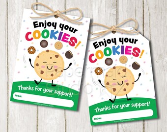 May include: Two printable gift tags featuring a cartoon cookie with a happy face juggling different types of Girl Scout cookies. The text on the tags reads "Enjoy your COOKIES!" and "Thanks for your support!"