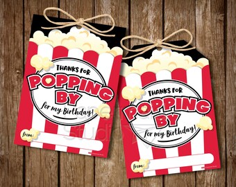 May include: Two red and white striped popcorn bucket favor tags with the text "Thanks for Popping By for my Birthday!" and a space to write "from:".