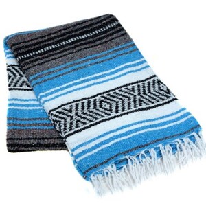 May include: A blue and white striped Mexican blanket with black accents and fringe. The blanket is folded in half and has a traditional design.