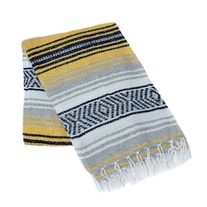 May include: A yellow, gray, and black striped Mexican blanket with white fringe.