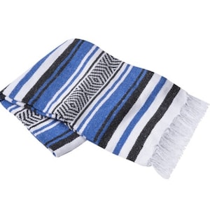 May include: A blue, white, and black striped Mexican blanket with fringe. The blanket is folded in half and has a geometric pattern.