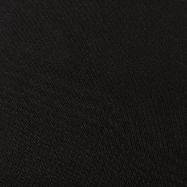May include: Black fabric with a textured surface.