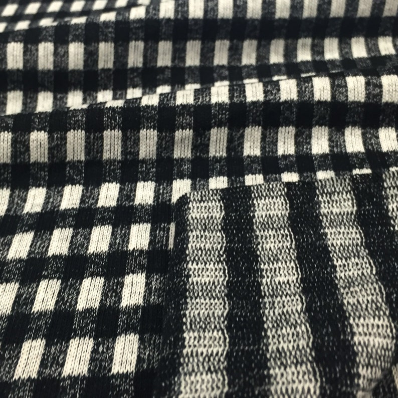 May include: Black and white checkered fabric with a black and white striped pattern.