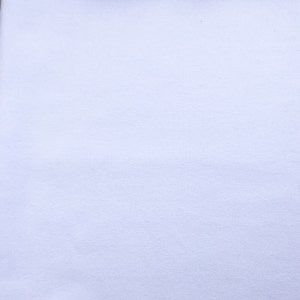 May include: A plain white fabric background.