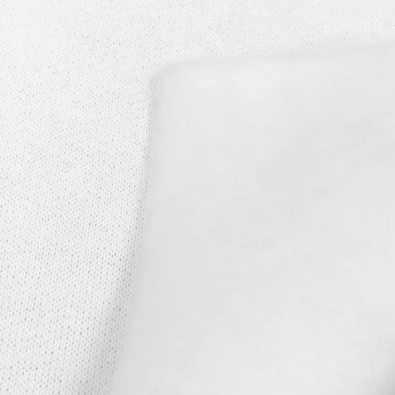 May include: White fabric with a textured surface. The fabric is smooth and has a subtle sheen.