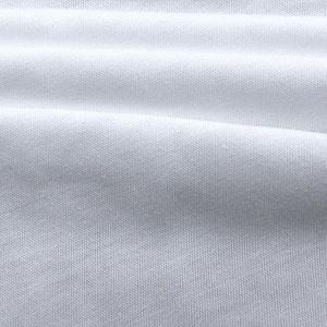 May include: Close-up of a white fabric with a smooth, textured surface. The fabric is folded and has a slight sheen.