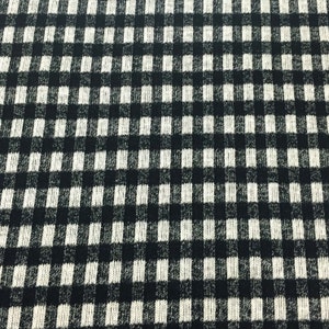 May include: Black and white checkered fabric with a textured knit pattern.