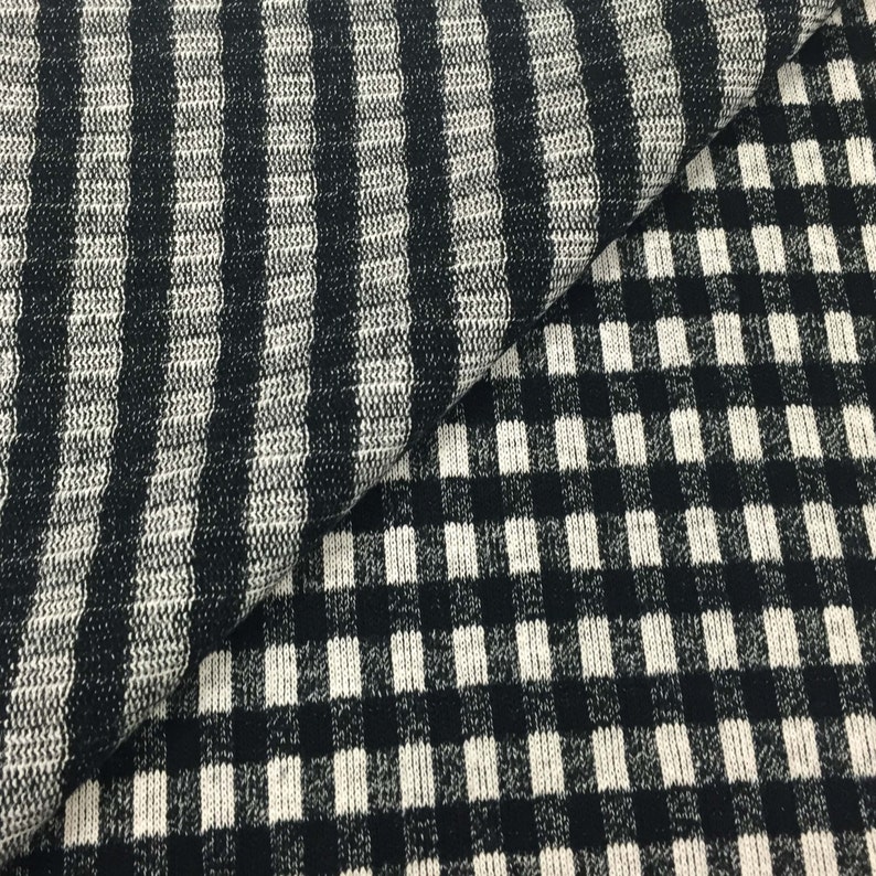May include: Black and white striped fabric with a black and white checkered pattern.