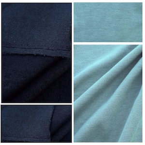 May include: Two fabric swatches, one black and one light blue. The black fabric is a knit with a textured surface. The light blue fabric is smooth and has a slight sheen.