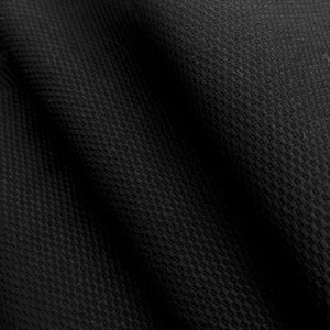 May include: Black fabric with a textured, woven pattern. The fabric is folded and has a slight sheen.